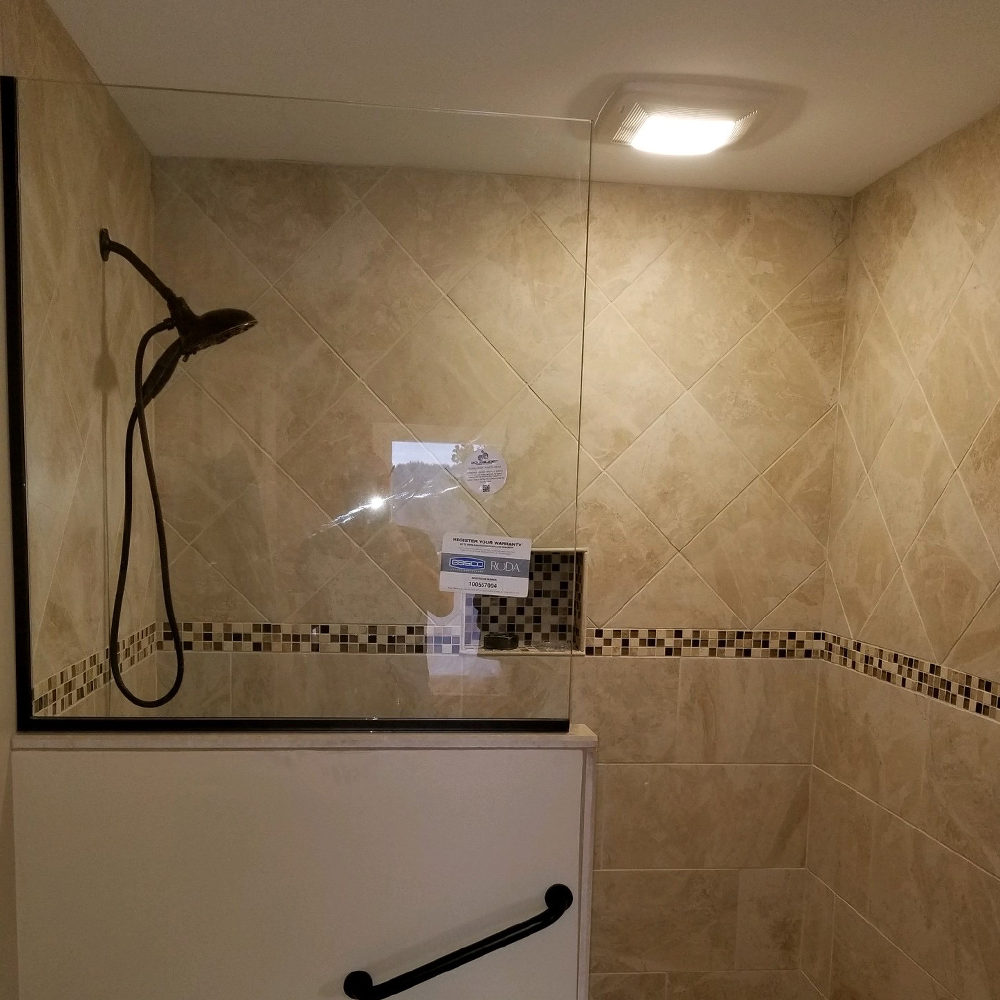 Half wall splash panel shower design by The Shower Door Specialists